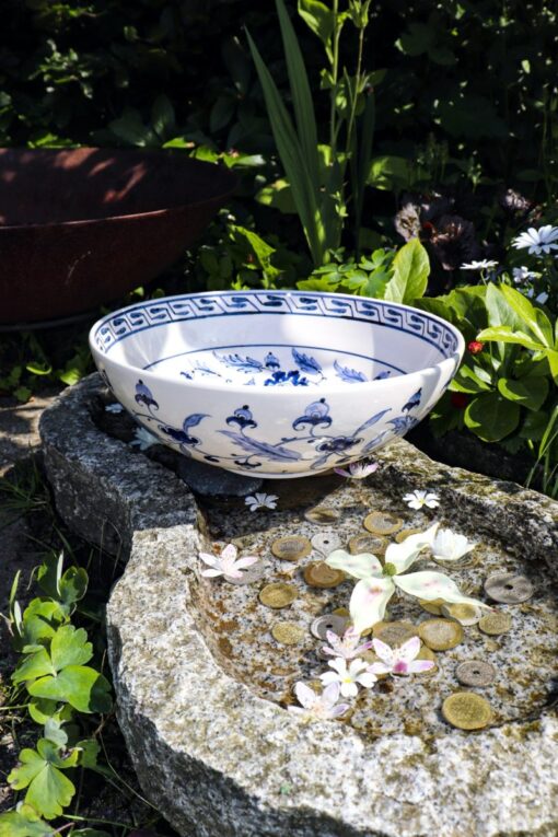 Lead free & handmade ceramic bowl with blue flower decoration on a white background