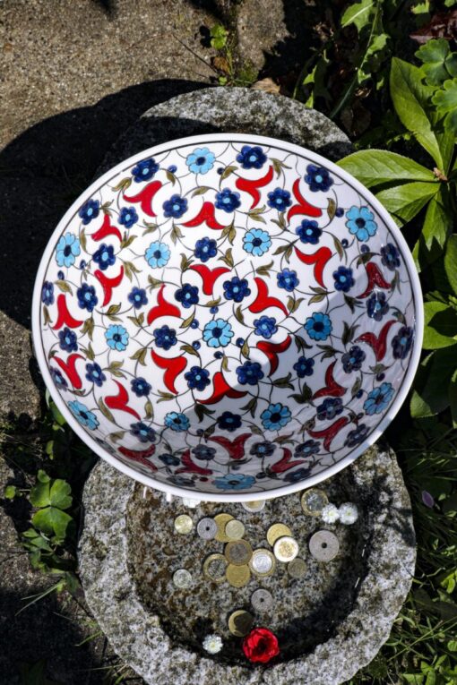 Lead free & handmade ceramic bowl with gorgeous blue and red colored floral decorations.