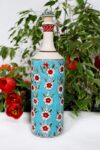 Handmade bottle with flowers in red and white on a turquoise background. Handpainted lid