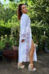 Ethnic caftan dress in white with colorful embroidery at the sleeves and in the front. Opens with buttons all the way down