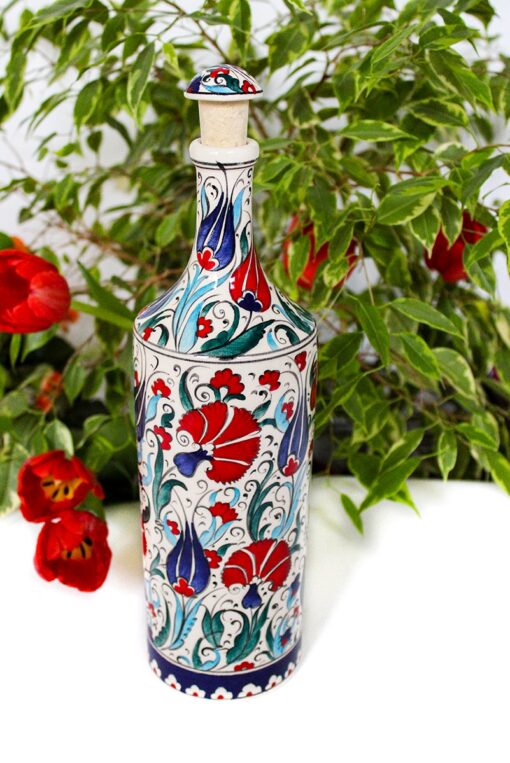 Handmade and decorative ceramic bottle with floral motifs of tulips and carnations in red and blue colors