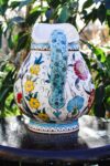 ceramic jug with floral wreaths decorated with colorful floral motifs