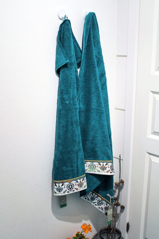 petrol colored soft organic towel set with detailed print at the bottom