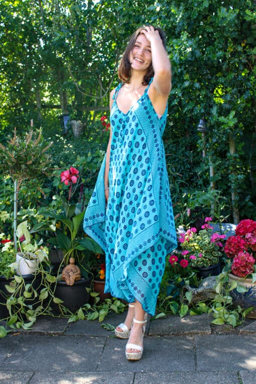 Soft airy dress with an asymmetrical cut in 2 layers. Watergreen with motifs